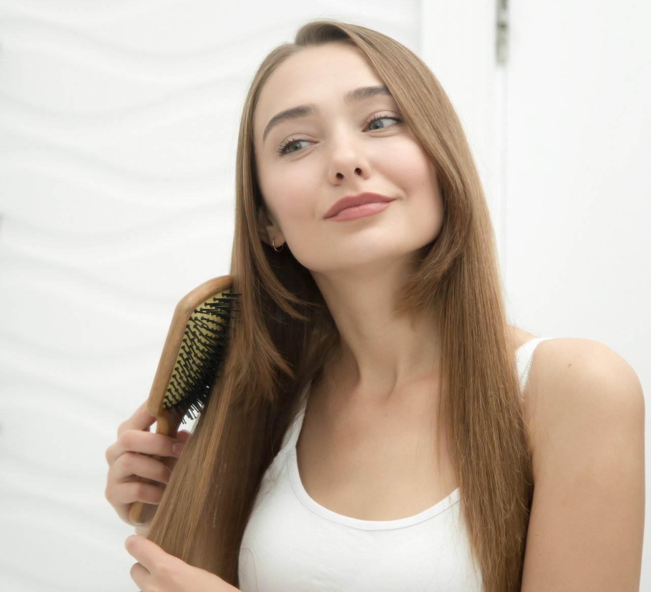 portrait-young-smiling-girl-brushing-her-hair